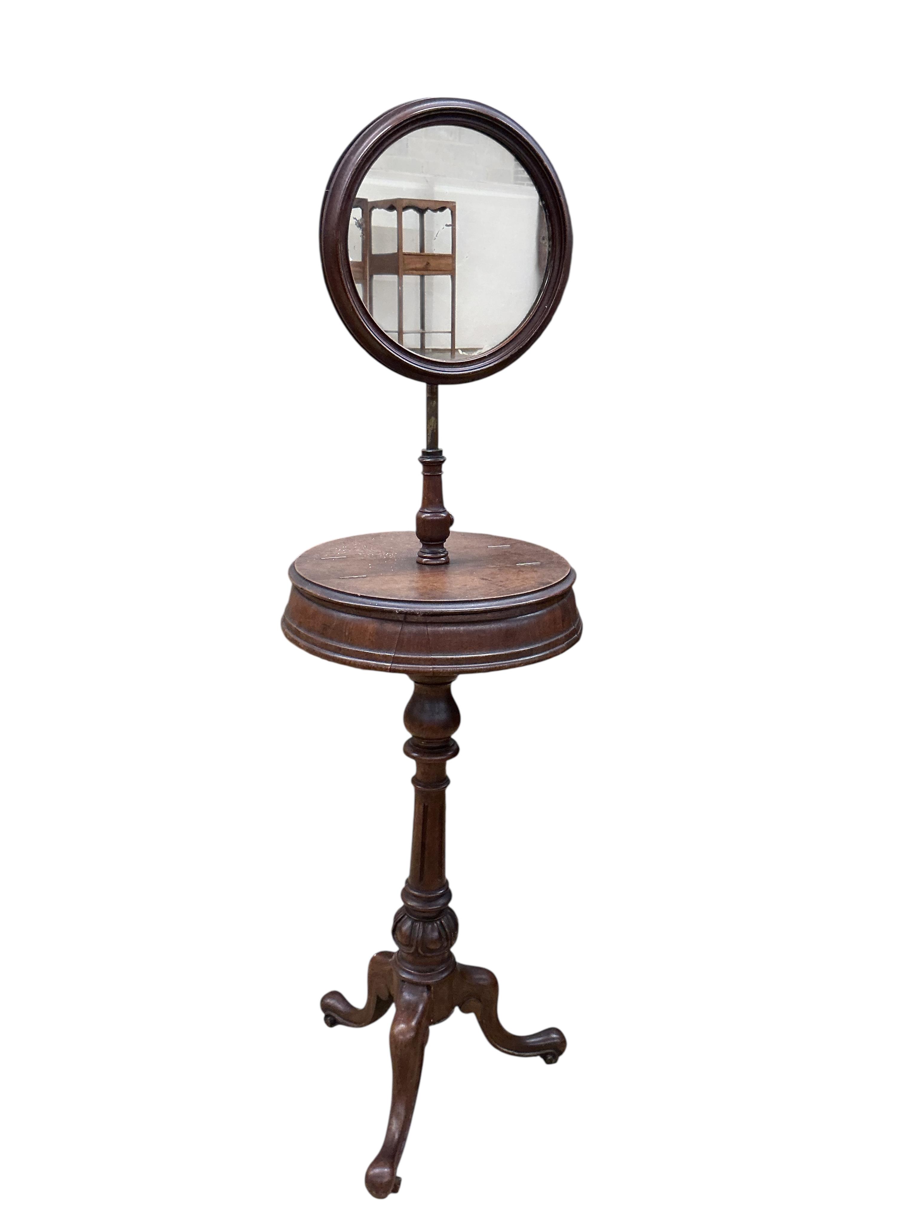 A Victorian mahogany shaving stand, with circular mirror and mid tier compartments, height 153cm